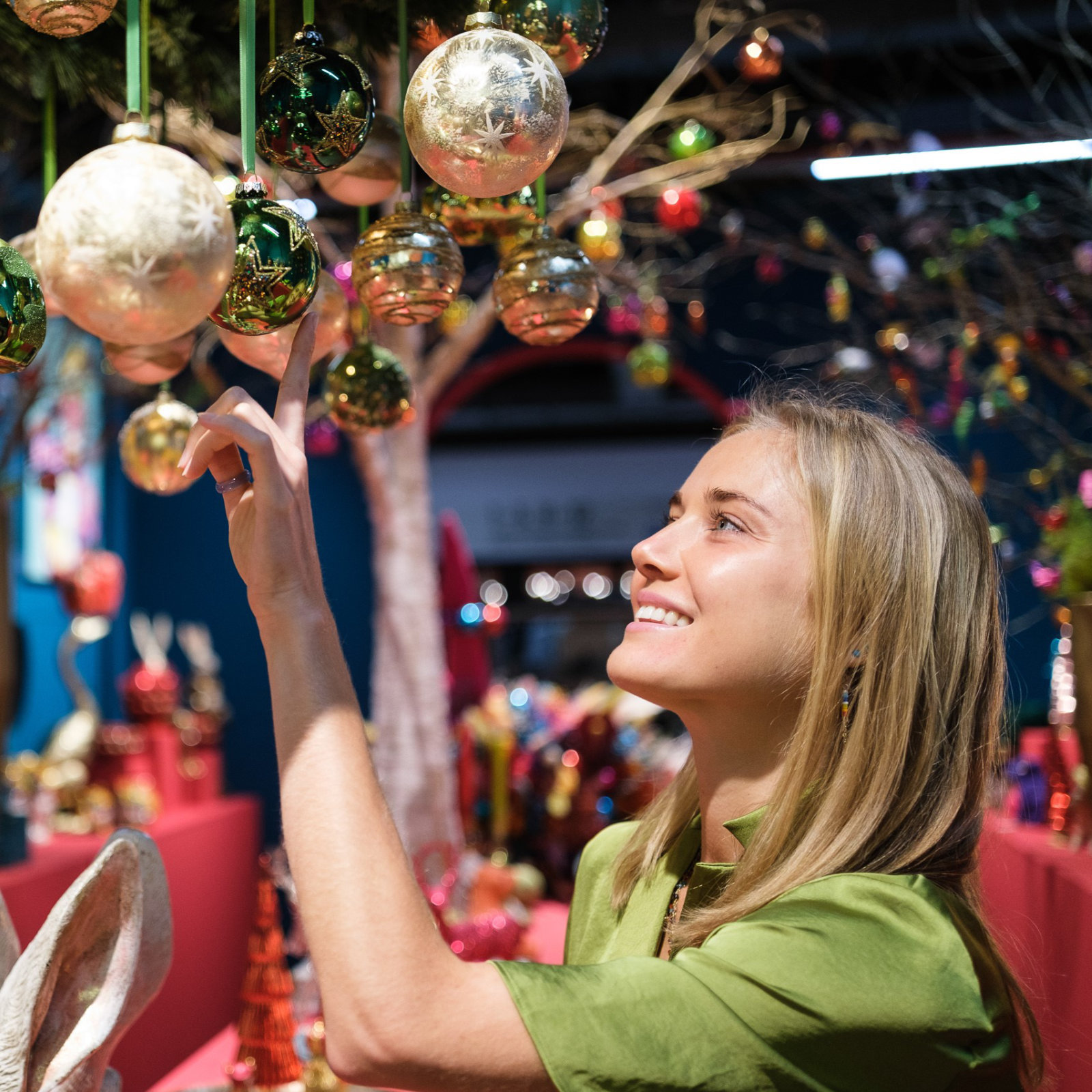 young woman with christmas baubles at Christmasworld