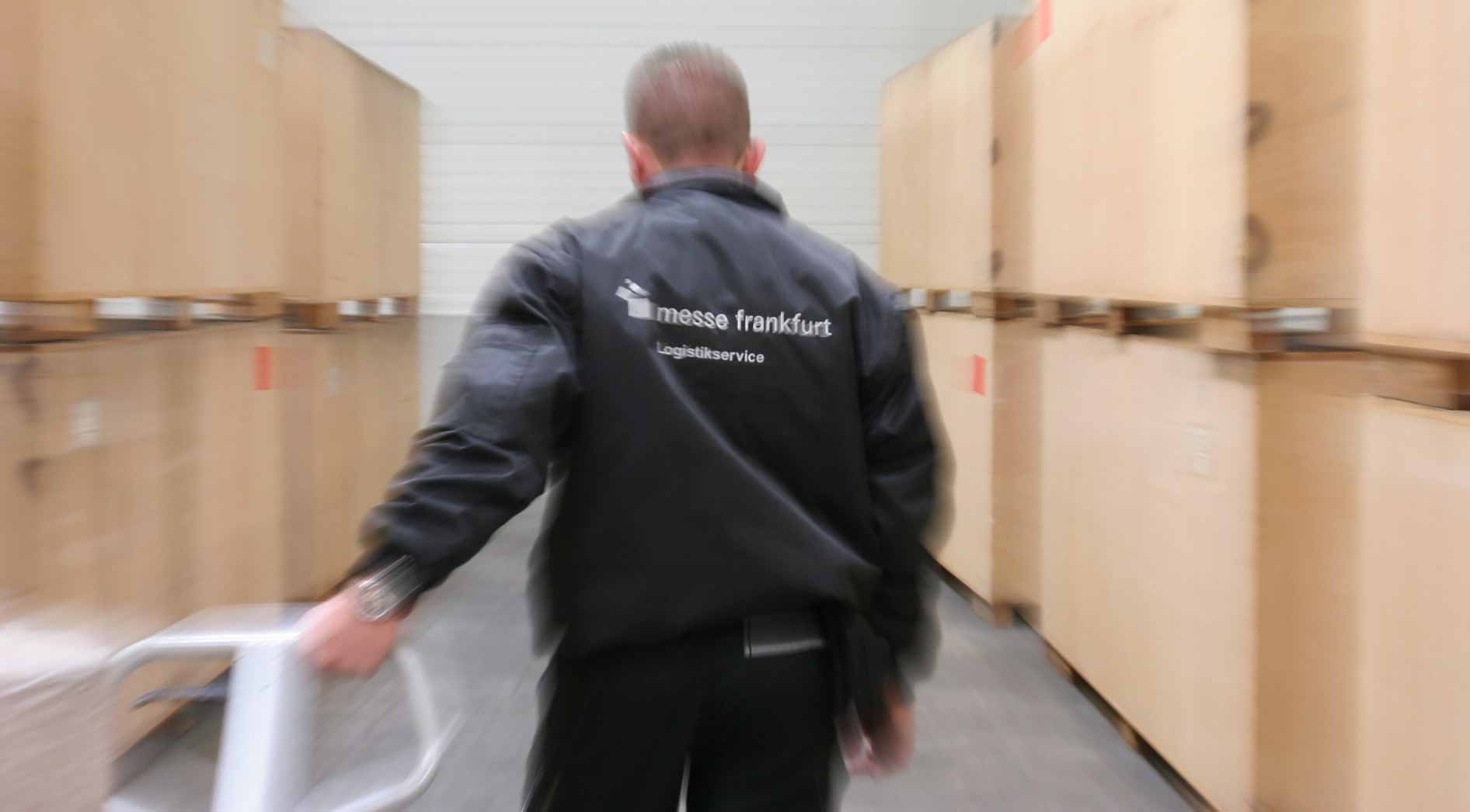 man pulls a pallet truck in the Cargo center of Messe Frankfurt
